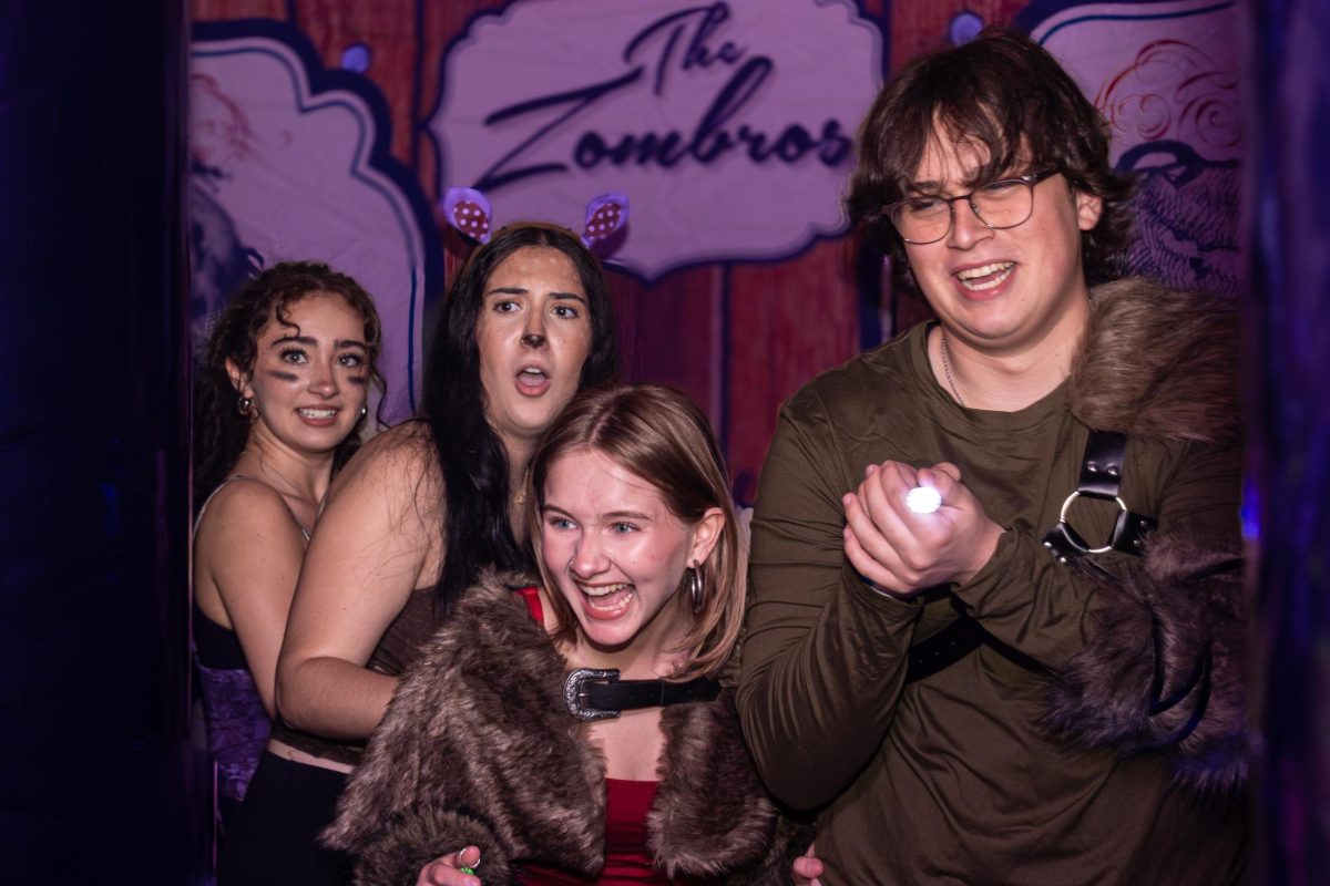 Making their way through the Fall Dance’s ‘Zombie Maze,’ theatre seniors Danielle Yodowitz, Hanna Lichtenthal, and Sher Wiedrich and Wiedrich’s extra guest encounter one of the many scare actors, consisting of Student Government Association (SGA) and student council members positioned across inflatable attractions. Featuring carnival games, obstacle courses and a dance floor to entertain attendees, the fall dance had an array of activities to entertain students and outside guests.