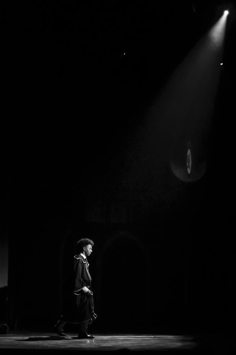 Walking towards the set depicting train platform 9 ¾, theatre senior Kevontay Oliver (Albus Potter) turns his back to the audience.