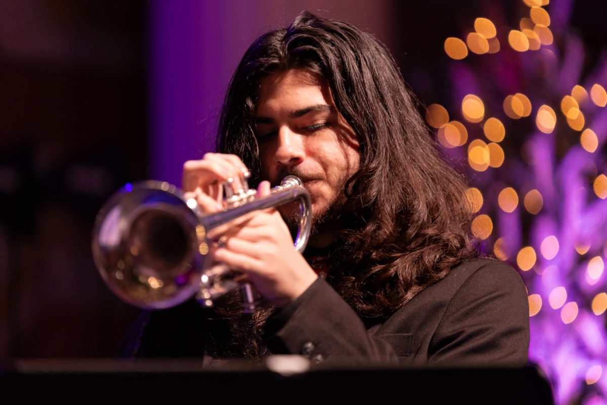 Performing a trumpet solo, band senior Nate Fong plays in a quartet jazz piece. (Landon D'Alessandro)