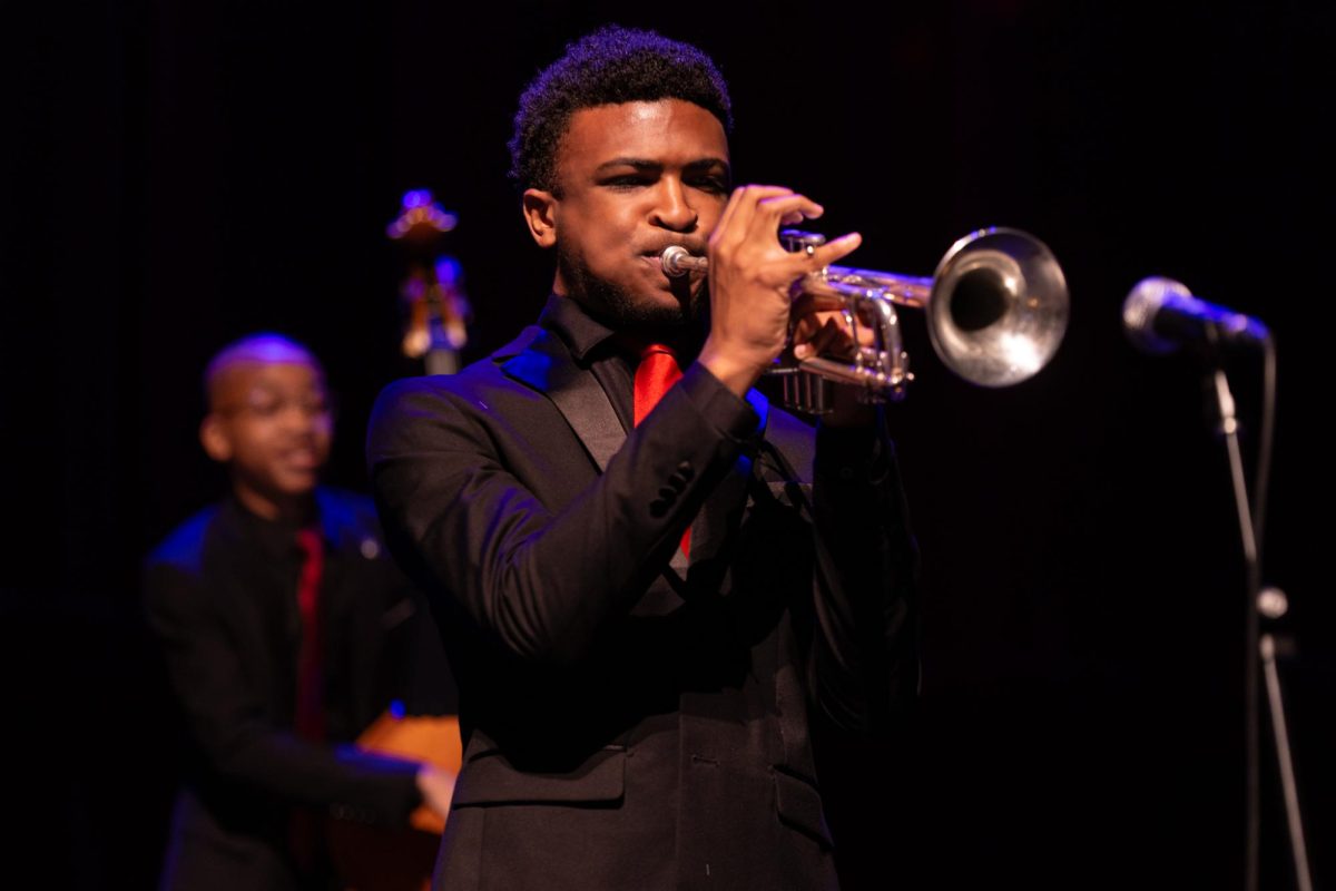 Pushing on the trumpet values, band senior Mathew Harper performs in a jazz quartet playing “Deck the Halls.” “In Prism, I really get to demonstrate the different facets of music I participate in,” Harper said. “It's really great to show the versatility I have been creating since freshmen students' year in front of my peers.”