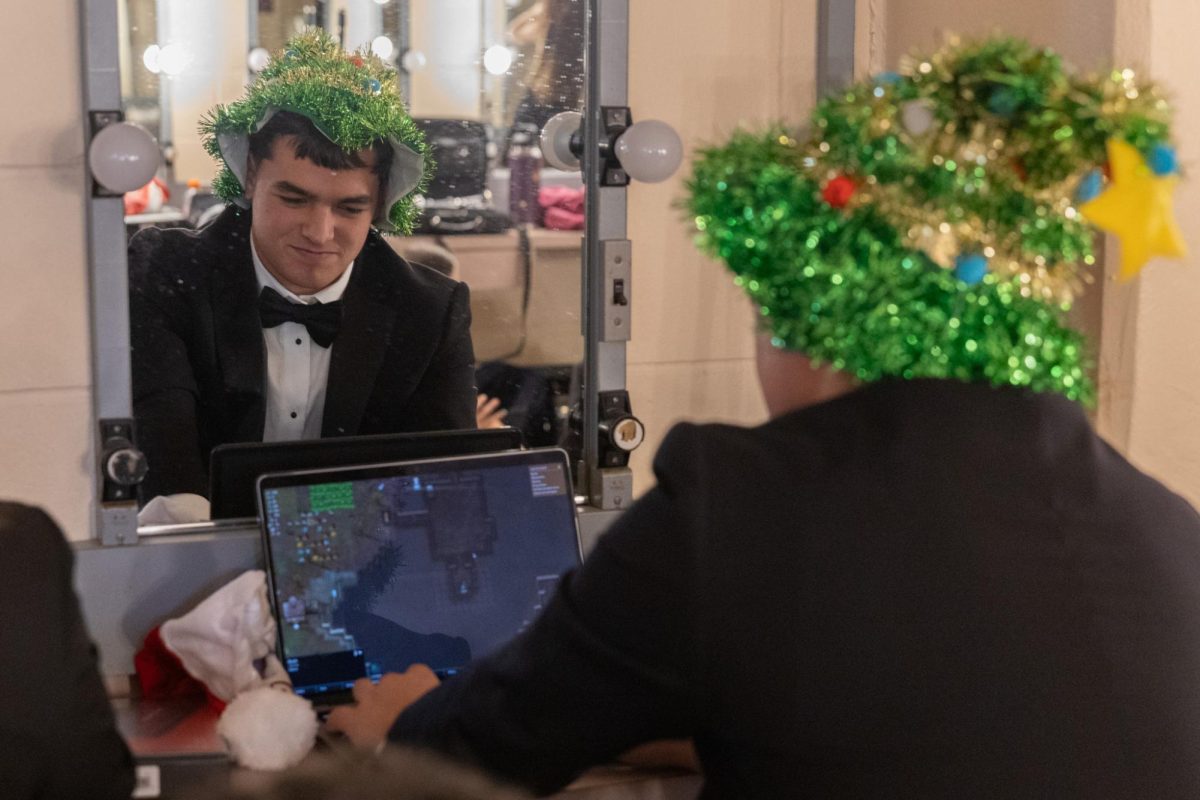 Mining downwards, band senior Sean Skatoff plays the indie video game, “Terraria” on his laptop. Students brought a variety of electronic devices to play games on during downtime from the Concert. Platforms ranged from Playstations to Nintendo Switches.