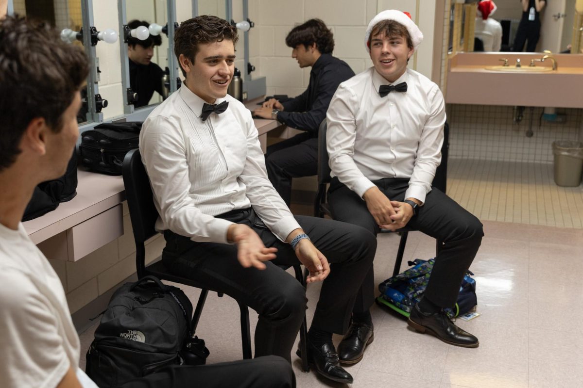Playing a round of Imposter, band seniors Jackson Murray and Christian Degan debate who knows the secret word. Those backstage during the Prism rehearsal played games with groups in their assigned rooms in the downtime between performances.