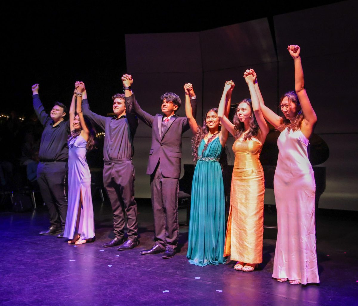 Raising their arms, the performers of the piano department’s Klavier Recital 2 give their final bow. The recital occurred Feb. 12 at the Brandt Black Box Theater.