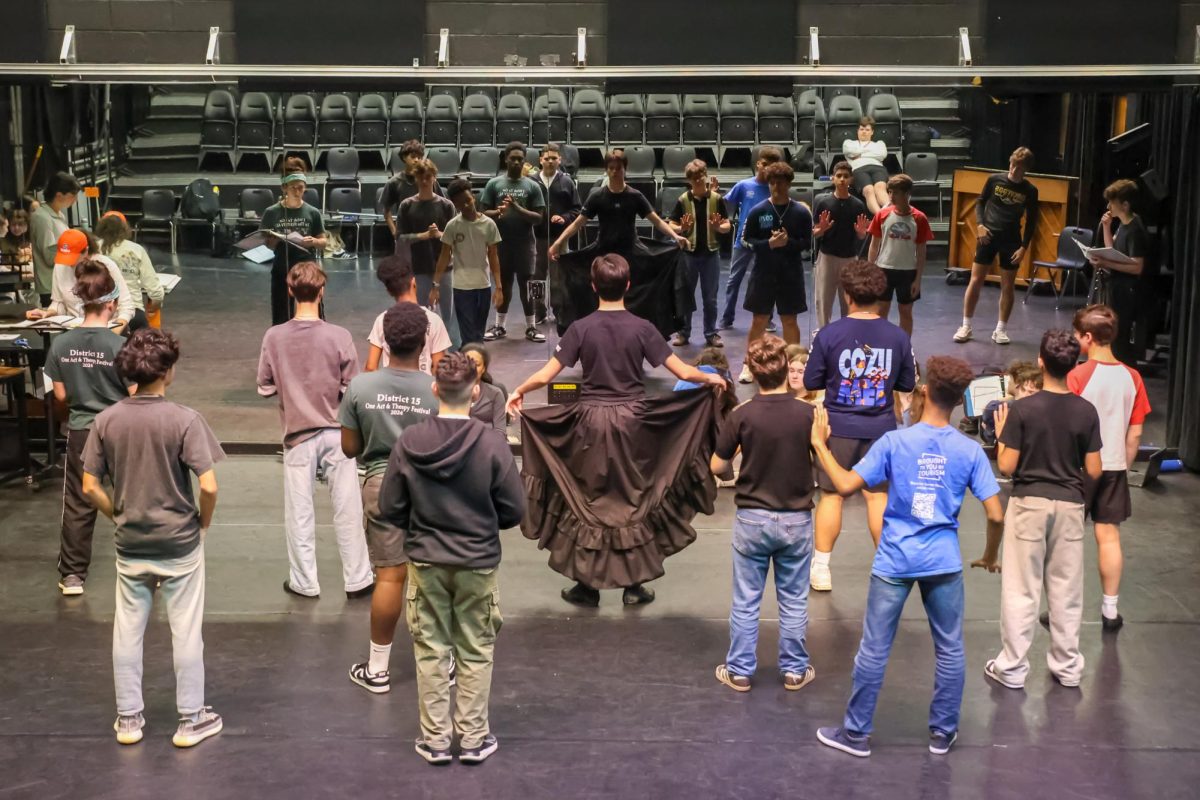 Leading the formation of a dance number, theatre sophomore Tristan Dominguez opens up his dress while playing Robin, a cross-dressing character. In the time-frame of the story, females were not allowed to be actors, so male actors would cross-dress to enact a female character.