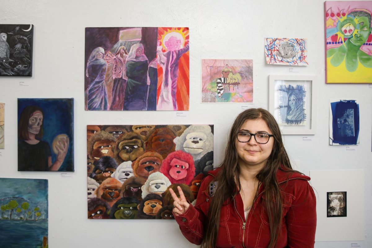 Visual freshman Whillow Osvath poses with her art piece. “I feel a sense of doom (with my piece), but also a sense of hope, because it's signaling my new journey at Dreyfoos,” Osvath said. “I hope that it continues to be positive, and that I can finally just have a good piece here because I can be so myself and so individual. Everyone's different.”