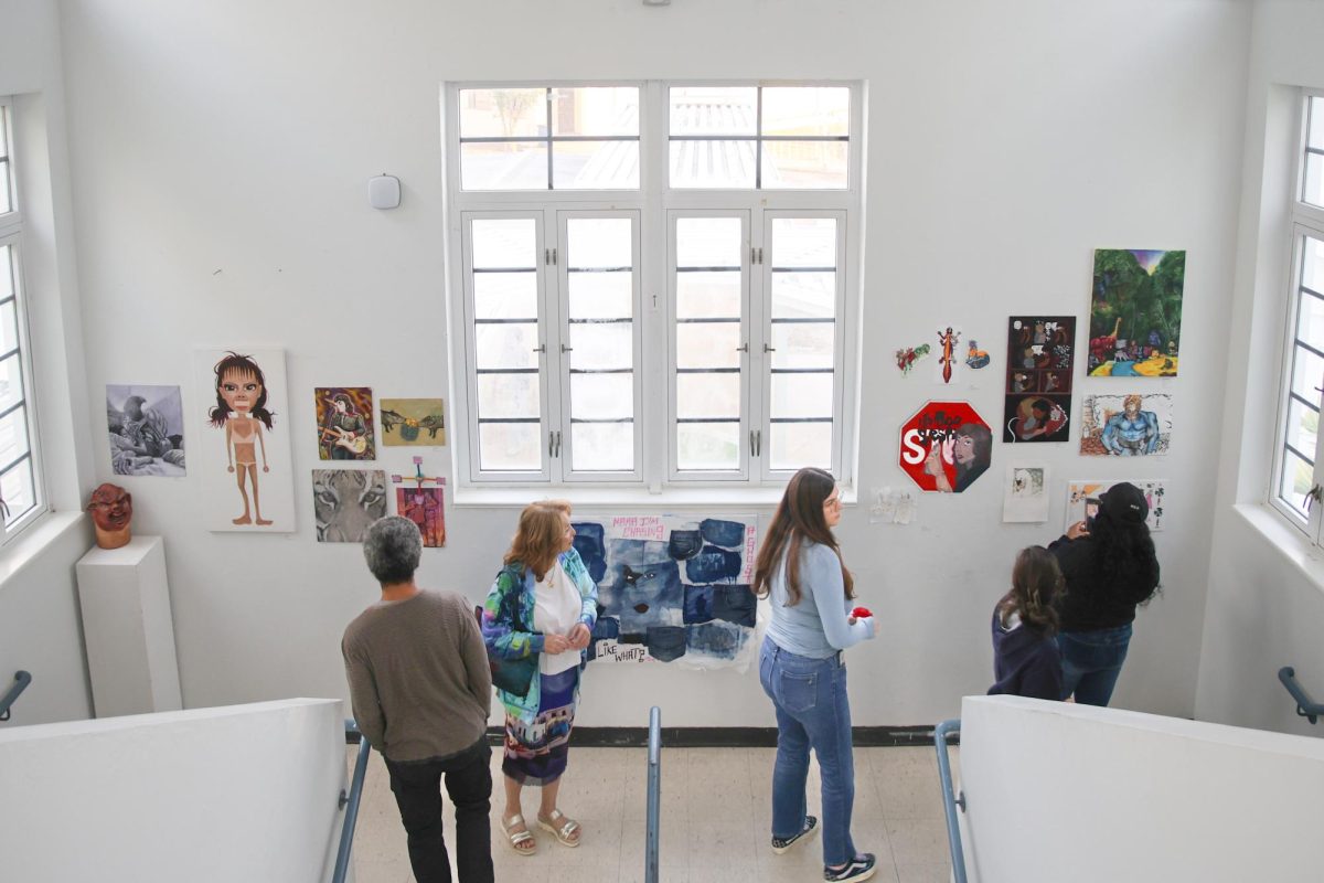 Observing artwork made by visual and digital arts and photography students, guests walk through the Building 9 stairwell. Over 75 art pieces were displayed in the Building 2 and 9 galleries. 