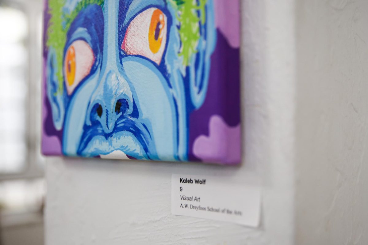 Hanging on a wall, visual freshman Kaleb Wolf’s art piece is displayed in Building 9 for the Visual and Digital Arts and Photography Spring Exhibition.