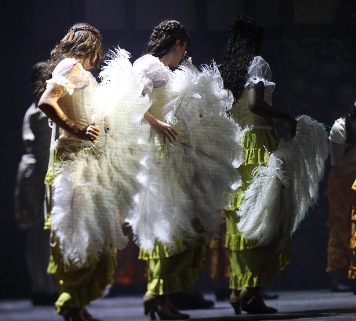 Holding feathered fans, theatre sophomore Sofia Carbone, theatre junior Adriana Orlando, and
theatre sophomore Kayla Leger perform the song “A Musical” during a dance number in the
production of “Something Rotten!”