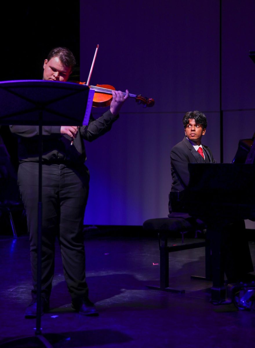 Observing his viola partner, piano junior Rishi Iyer plays Henri Vieuxtemps' “Elegie, Op. 30 for Viola & Piano” with band junior Zachary Grunwald. Grunwald and Iyer began planning to perform their piece in August and rehearsed during their first period chamber class. “It was really nice to see it come to life and all our hard work paid off,” Iyer said. “We finally got to perform it in front of an audience.” 