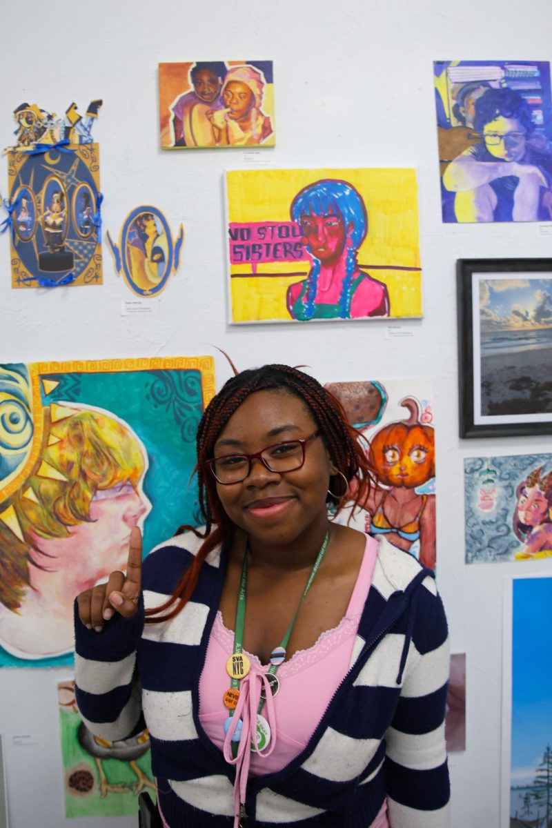 Visual sophomore A'Layshia Jean points to her art piece “Evanescence.” “I really got to connect with my family when I made this piece," Jean said. “I went back to my cousin (portrayed in the painting) and had a nice chat with her, which we haven't done for a while; it really inspired me to make this piece.”