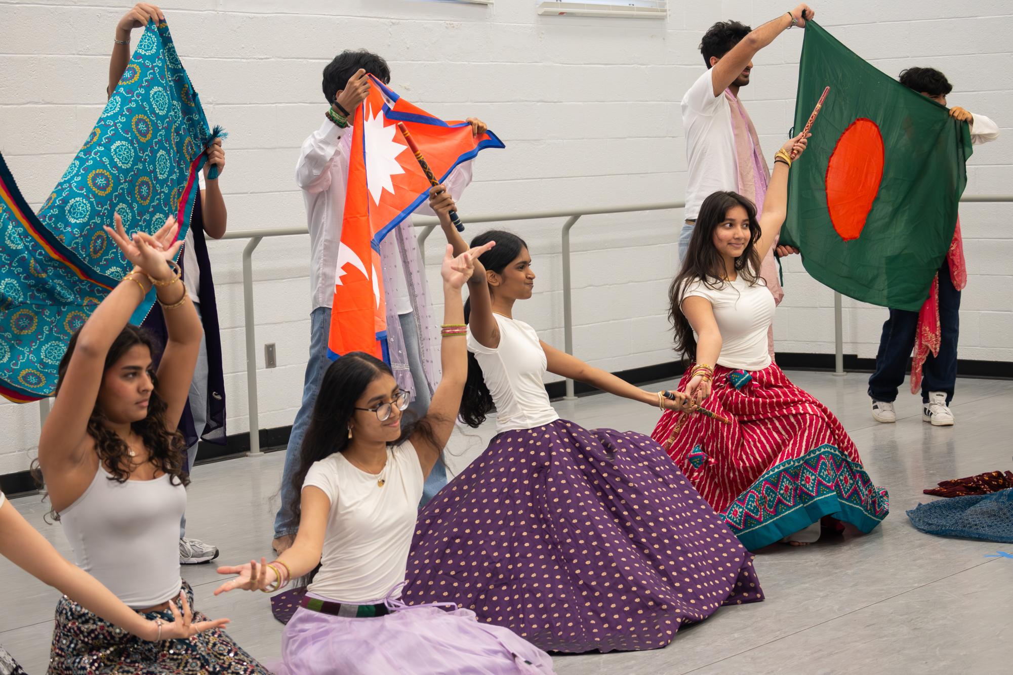 Presenting flags of countries represented in the multicultural show, vocal junior Vidya Muthu and her multicultural group conduct the final moments of their performance. “We started prepping at the very beginning of the year, during August, and we started thinking about the songs we’d do as well as the choreography,” Muthu said. “We would meet after school to create choreographies for our dances, and later we asked anyone interested to join.” 

