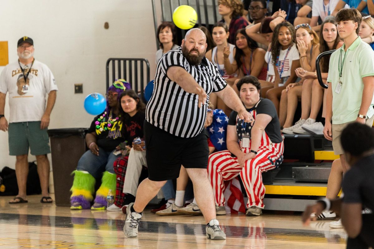  Launching a dodgeball, assistant principal William Clark participates in the teacher versus student round of the Spirit Week dodgeball tournament. The student winners of the tournament, the seniors, competed against a teacher team in a surprise round. “When our students see us buying into the things happening on campus, dressing up and participating in events, I think it encourages those students who may be on the fence to jump in and be part of it all,” Mr. Clark said.

