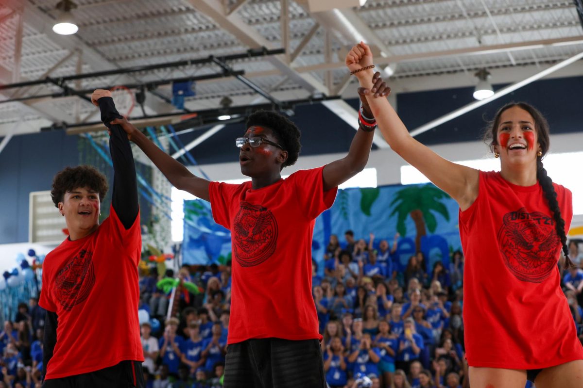 Holding theatre junior Richard Moore, acting as Peeta Mellark, and dance junior Matea Marquez, playing Katniss Everdeen, with their arms raised, theatre junior Jonas Jacob Joseph proclaims the pair champions of the Hunger Games during the junior class’s Pep Rally dance. To fit SGA’s overarching theme, “Dreyfoos On Demand,” the junior class council selected “The Hunger Games” as its theme.