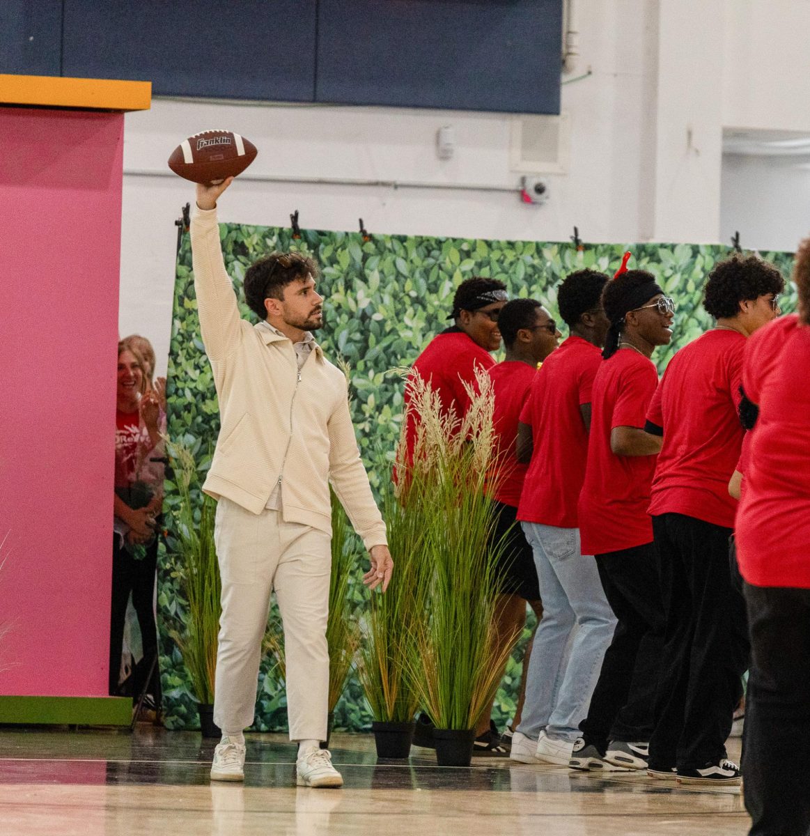 Raising a football, digital arts and photography teacher Nicolas Angulo appears as Puerto Rican artist Bad Bunny during the pep rally. Inspired by Bad Bunny’s 2026 Super Bowl Halftime Show, Mr. Angulo, along with English teacher Carmen Gallardo, math teacher Traci De Leon, theatre teacher Sandra Christie, and Spanish teacher Monica Zarini, danced to “BAILE INoLVIDABLE,” “NUEVAYoL,” and “DtMF” during the staff’s performance. 