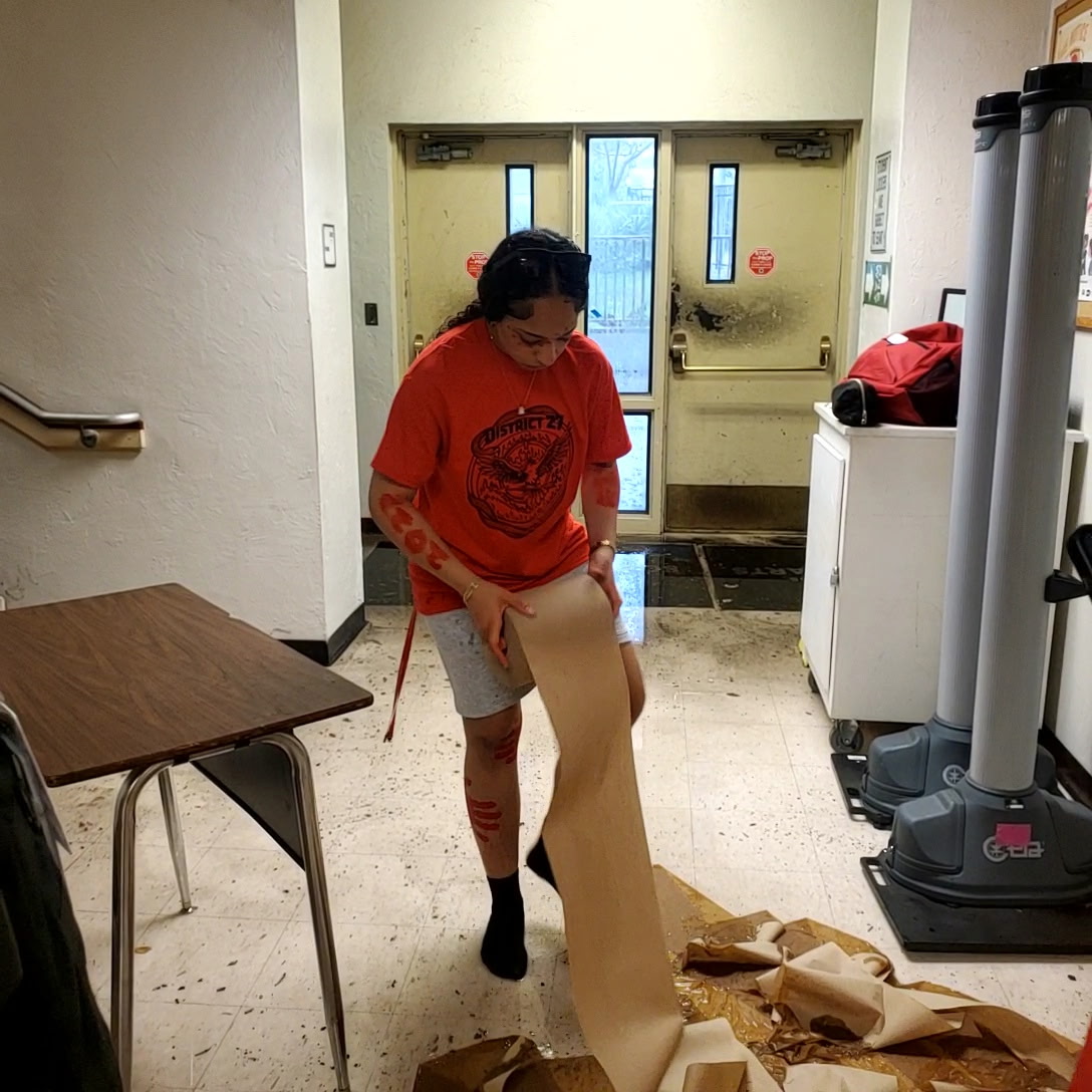 Cleaning up floodwater that trickled into Building 3, vocal junior Alexa Butler unravels paper towels. "I just jumped over a puddle of water and water started coming inside," Butler said, "We tried to close the doors."

Photo Courtesy of English teacher Alicia Barton