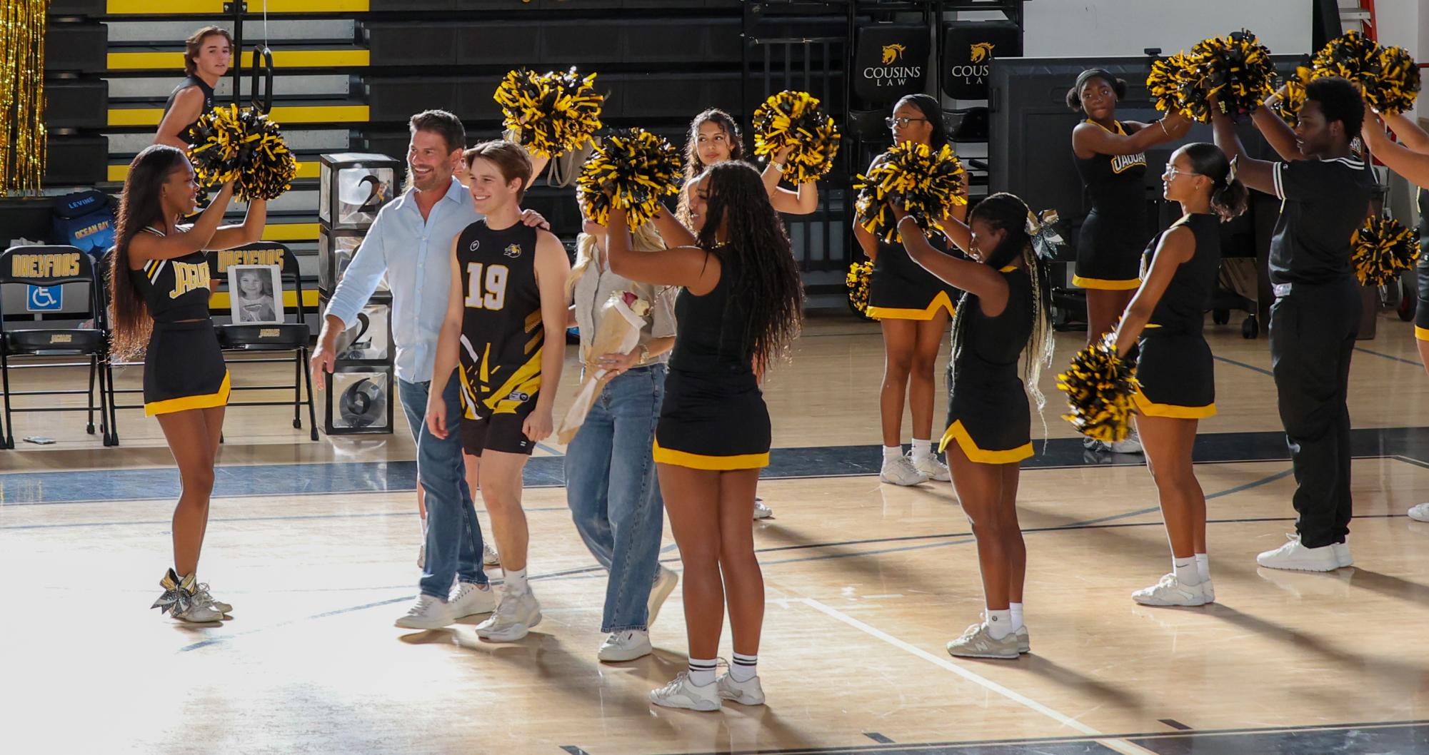 As the cheer team welcomes the seniors onto the court, vocal senior Jack Meller walks through the line accompanied by his parents. “I feel like it's pretty sad because I've been on it (the team) all four years of high school, and I really can't imagine myself leaving because it was just such an amazing experience for me,” Meller said. “It's like a second family, because we've just created this special bond, and I mean nothing else compares to it. I just love and cherish the memories I've had with all of my teammates."