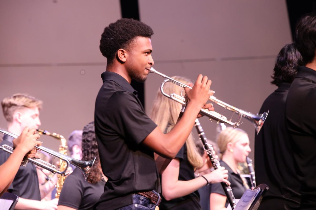  Performing in the Veterans Day concert, band senior Mathew Harper plays a piece on his trumpet. 