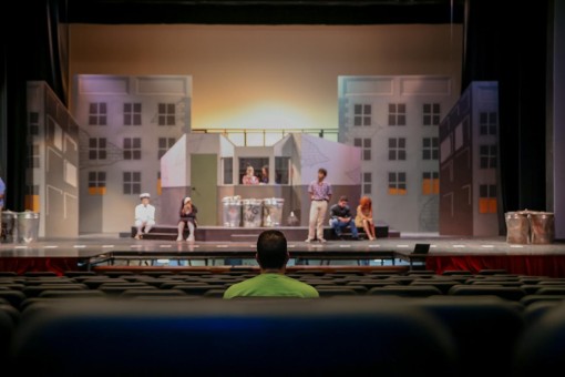 As the actors conduct mic checks, theatre teacher and director Charles Swan observes from the audience, analyzing the stage for any flaws before the first full runthrough in Meyer Hall.