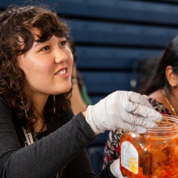 Vocal senior Amelia Williams passes out various foods at the Multicultural Potluck on Nov. 16 during lunch in the gym. Students across campus brought in foods that represent their culture and heritage.