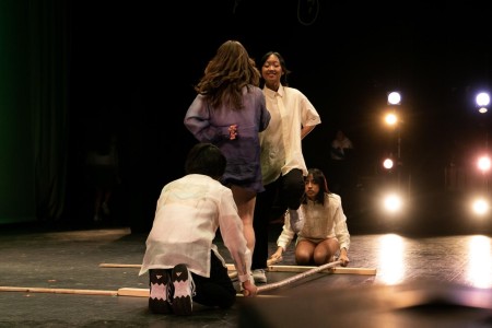 Digital media junior Jeselle Tortugo, visual seniors Alyssa McIntosh and Brenda Cruz, and band junior James Belden Tadiaman participate in Tinikling, a traditional Filipino dance.