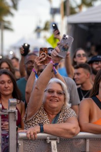 As the sun sets, a SunFest attendee waves her iPhone flashlight back and forth during “Dear Mama” (Dibut’s tribute to her mom for Mother’s Day).