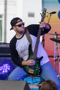 Marvin Ray Hawkins, a bassist for Shaw Davis & the Black Ties, rocks out to their song on the Sandbar Stage Powered by F-150 Lighting.