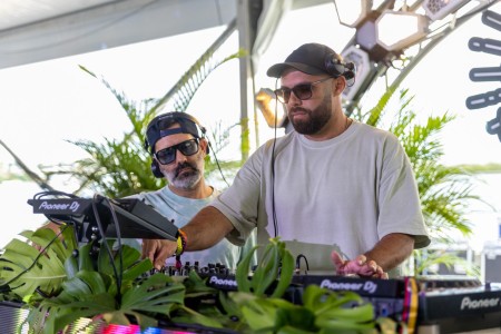 DJs J Martinez and German Garcia mix various EDM tracks on the SunFest Electronic Barge, a floating dance club.