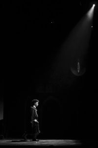 Walking towards the set depicting train platform 9 ¾, theatre senior Kevontay Oliver (Albus Potter) turns his back to the audience.
