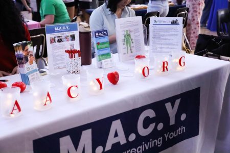 Candles light up the table of M.A.C.Y., which is run by the American Association of Caregiving
Youth (AACY) organization, at the annual mental health expo. They bring awareness to youth
under the age of 18 who are long term caregivers for ailing family members dealing with chronic
illnesses.