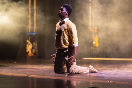 Kneeling during an interpretive dance to Sam Cooke’s “A Change is Going to Come,” theatre sophomore Jonathan Williams faces the audience while a screen projects historical African American figures behind him. “The most important thing about my performance was to relay the message of struggle and being able to overcome it,” Williams said.