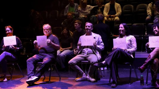 Holding up their whiteboards, English teachers Brittany Rigdon, Thomas Ruth, Nathan Hesse, Carmen Gallardo, and Moriah Carlisle volunteer as judges for “Slam Jam.”
