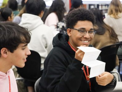 Presenting his origami progress, visual junior Marcalix Lemene crafts with his peers. Origami is traditionally created with a single square sheet of paper, excluding glue or tape. After following a demonstration, students got the opportunity to experiment with the art.