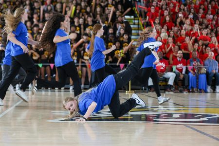 Pushing her arms onto the ground and sticking the lower half of her body into the air, dance freshman Waverly Summerill participates in the freshman class dance during the Pep Rally March 14.