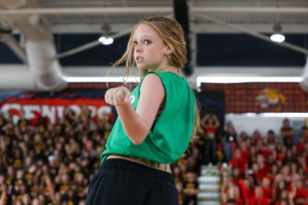 Sticking her hand out and looking back toward the sophomore class, dance sophomore Aria Chesser — the dance choreographer for the class of 2028 — participates in the class of 2028’s Pep Rally dance. The sophomore’s class theme was “Zombies” — a musical that premiered as a Disney Channel Original Movie — where dancers were told to imitate choreography and zombie-like movements from the film.
