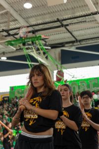 Propping an inflatable bat on her shoulder, dance senior Karina Mitten walks across the gym floor during the senior walk-in. Referring to Nancy Wheeler’s baseball bat from the show “Stranger Things,” the walk-in featured soundtracks from the show.