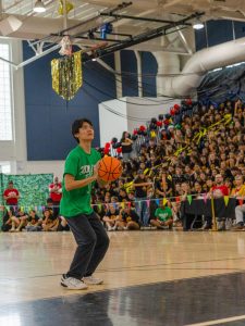 Ball in hand, strings sophomore Jayden Bai participates in the free throw competition. Bai, along with piano sophomore Matheson McCumber, won the free throw competition last year, but fell to the seniors in a tie-breaking 6-7 loss this year.