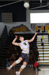 Preparing to serve, theatre junior and team libero Brayden Levine hits the ball towards the opposing team during the match against Palm Beach Gardens High School.