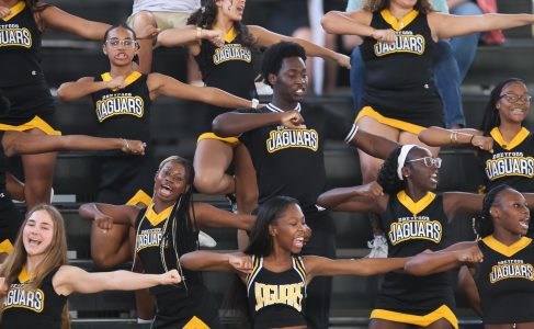 Led by theatre junior and cheer co-captain Mykell Brown, the cheer team performs a chant after the boys’ volleyball team scored a point against Palm Beach Gardens High School.