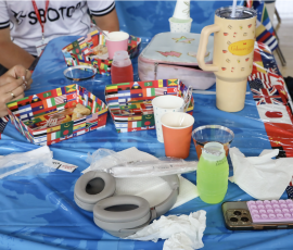 A table showing the finished dishes after students shared the multicultural food among each other. The selection included a selection of cookies, chicken wings, and a variety of drinks.