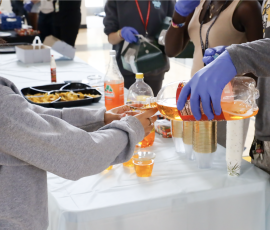 Digital senior Joseph Floreal pours D&G “Genuine Jamaican Kola” into visual junior Juana Sanchez-Mendoza’s cup.